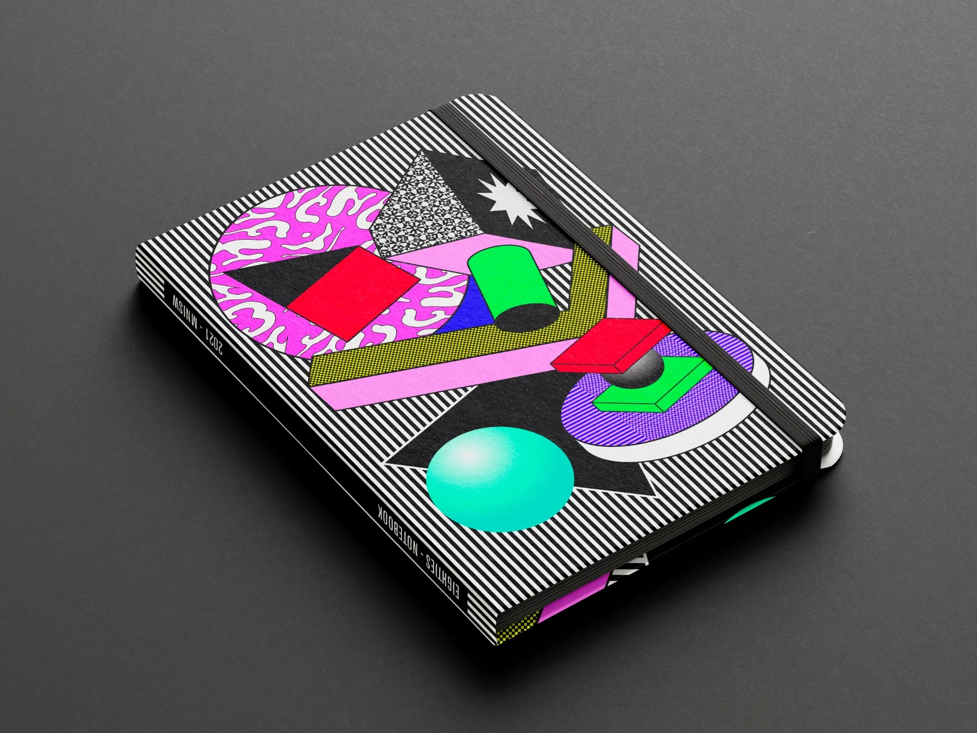 Notebook on black background with a cover composed of a pop illustration with graphic forms