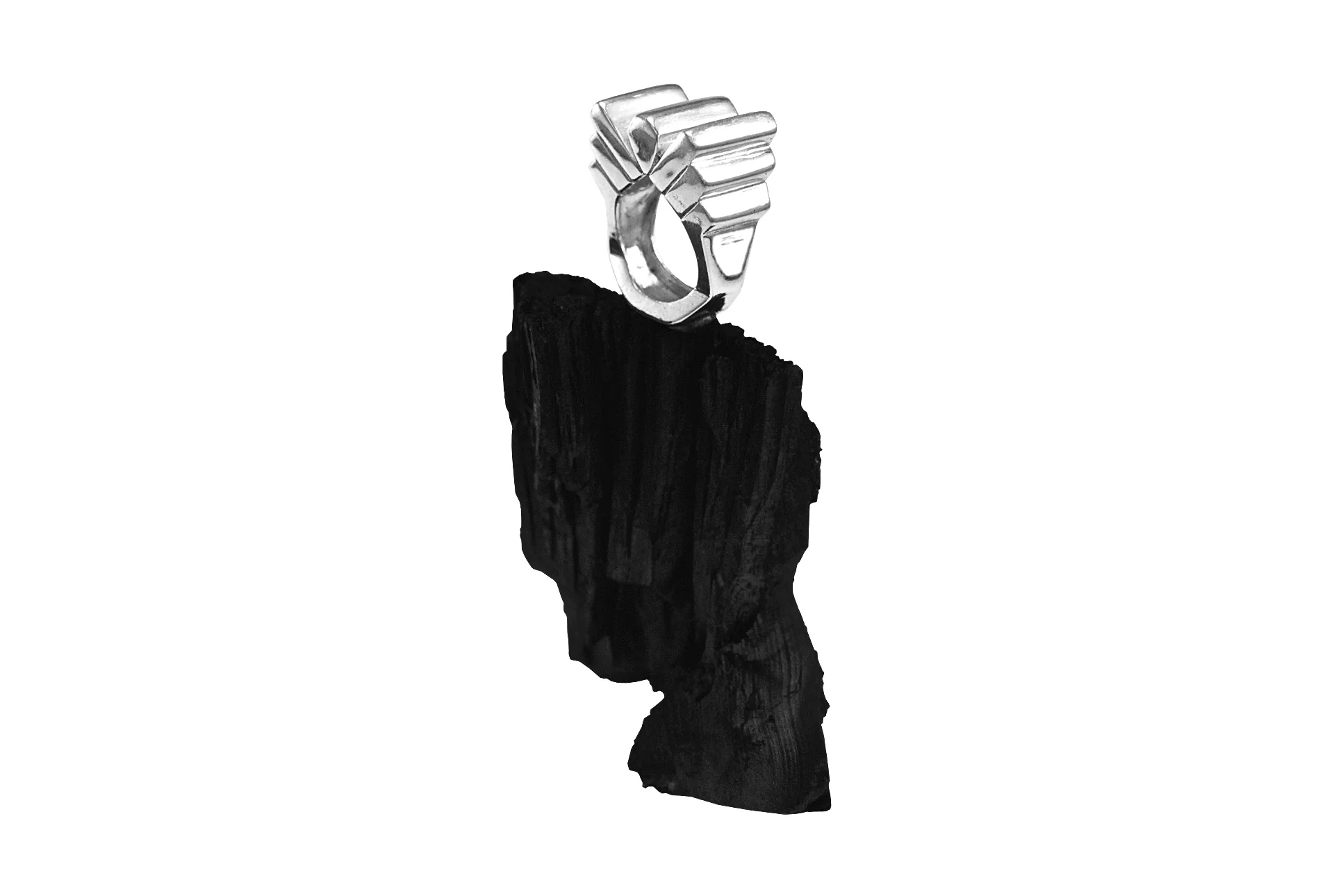 Photograph featuring a ring on black coal
