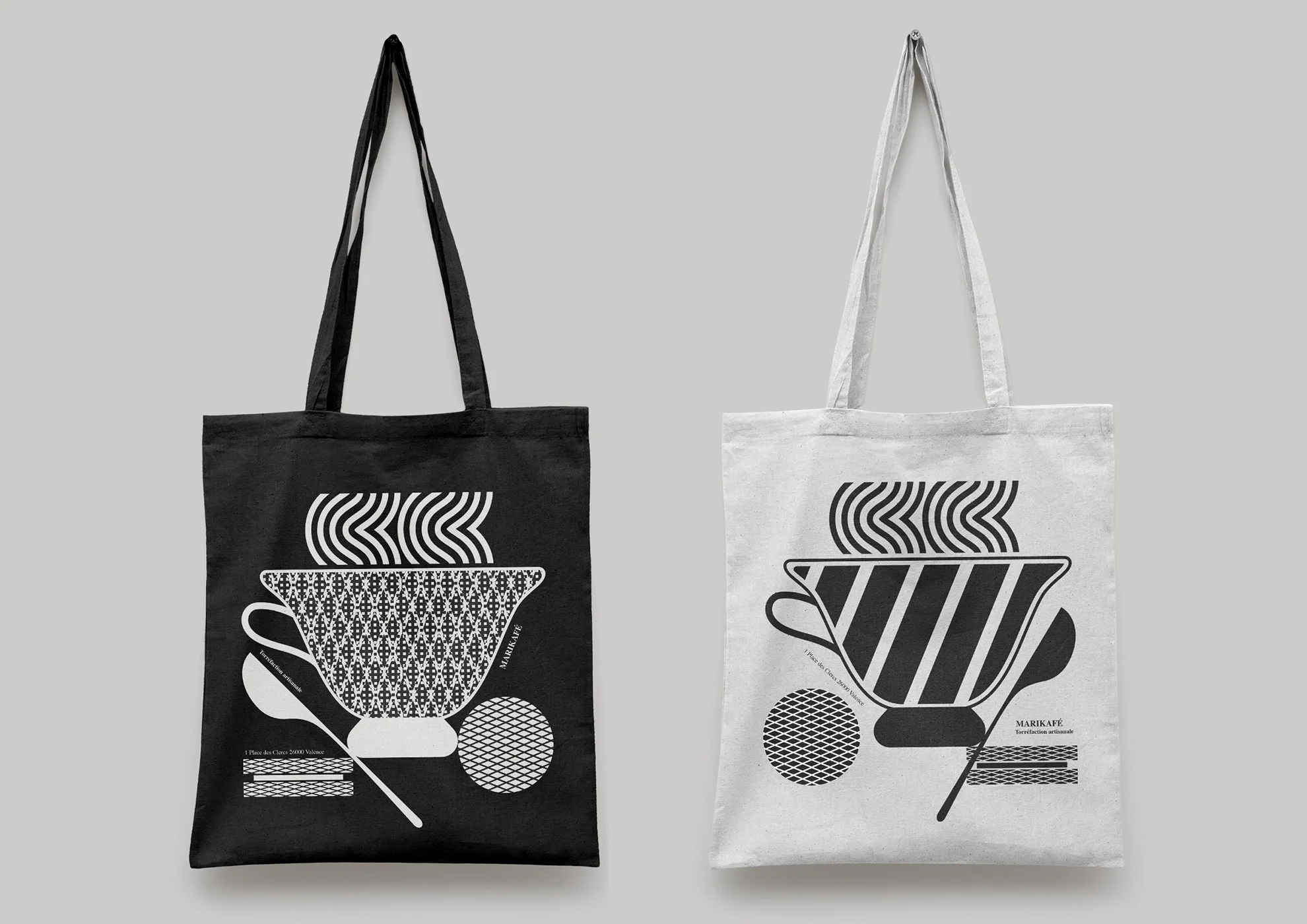 2 black and white canvas bags from a coffee brand