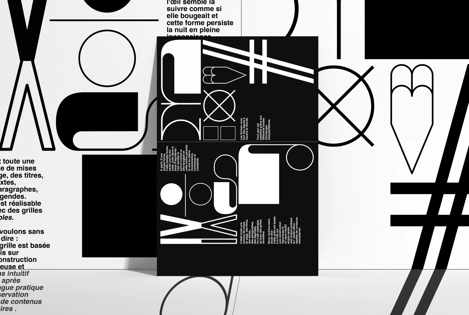 Letterpress poster in black and white on a wall covered with typographic signs